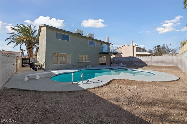 view of pool with a diving board and a patio