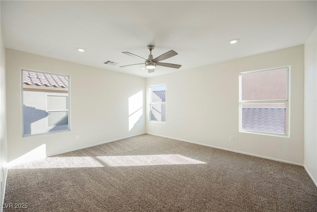 empty room with ceiling fan and carpet