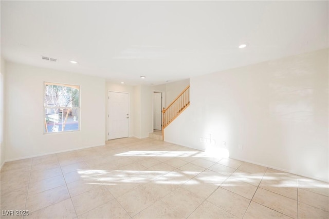 spare room featuring light tile patterned flooring