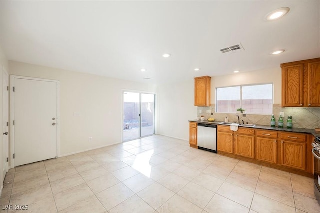 kitchen featuring a wealth of natural light, appliances with stainless steel finishes, decorative backsplash, and sink