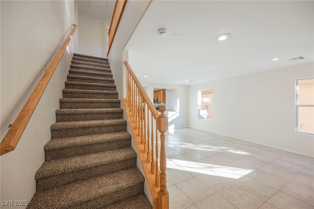 staircase featuring tile patterned flooring