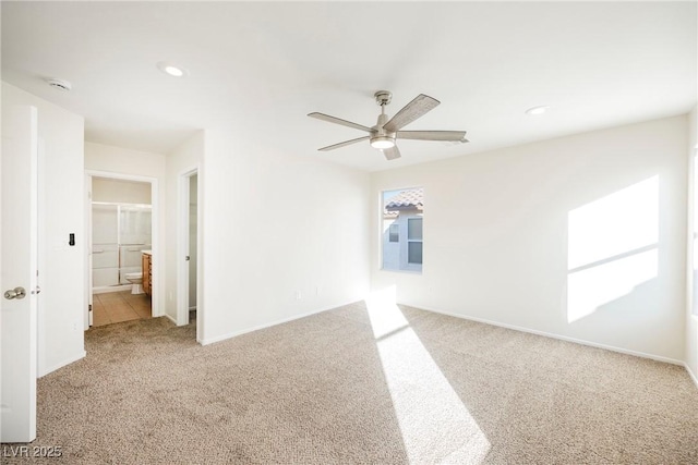 spare room featuring ceiling fan and light colored carpet