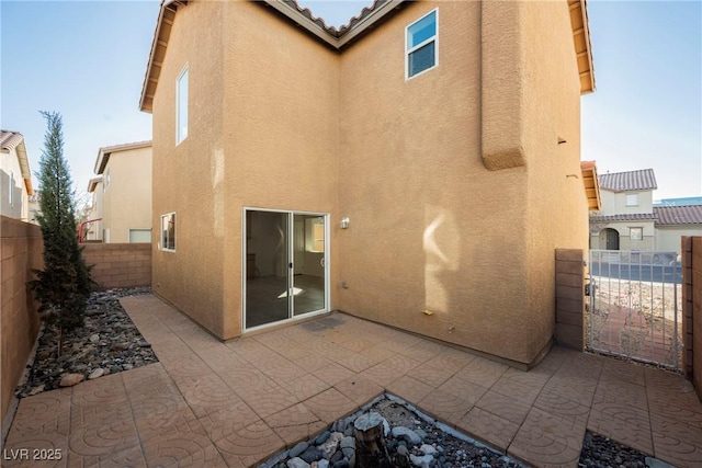 back of house with a patio