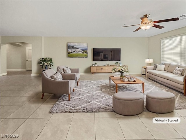 living room with ceiling fan and light tile patterned flooring