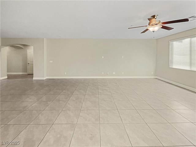 tiled spare room with ceiling fan