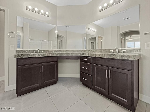 bathroom with vanity, ceiling fan, tile patterned flooring, and a shower with door