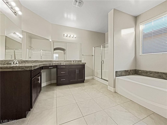 bathroom with plus walk in shower, tile patterned flooring, and vanity