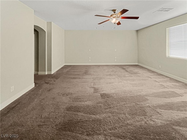 unfurnished room featuring ceiling fan and carpet floors