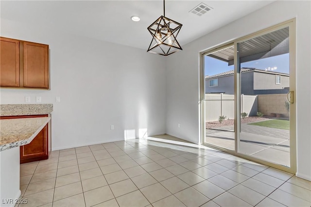 unfurnished dining area with light tile patterned floors