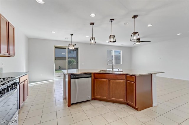 kitchen featuring decorative light fixtures, a kitchen island with sink, dishwasher, range, and sink