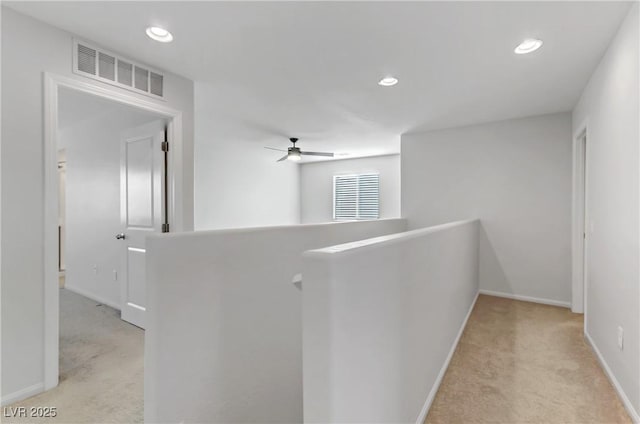 hallway featuring light colored carpet