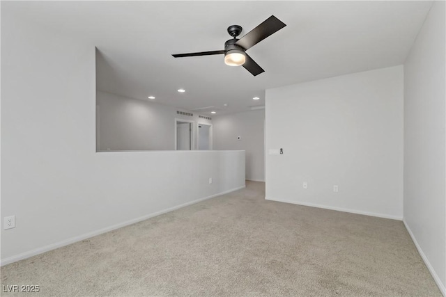 spare room with light carpet and ceiling fan