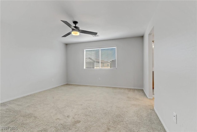 carpeted empty room featuring ceiling fan