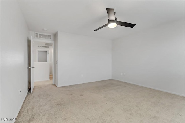 spare room with ceiling fan and light carpet