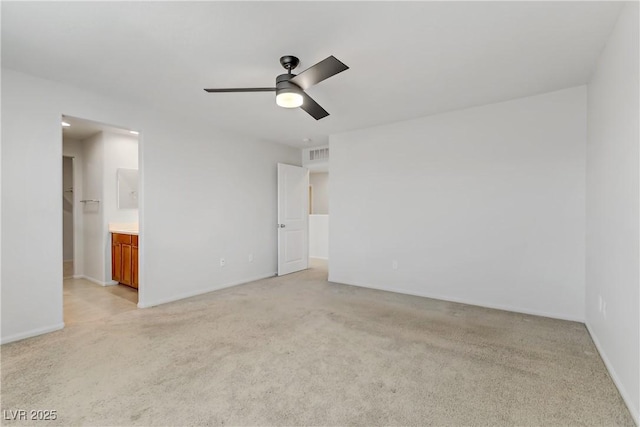 spare room featuring ceiling fan and light colored carpet