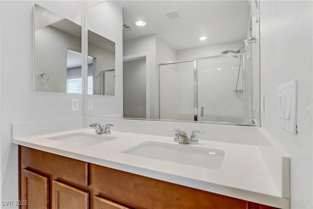 bathroom with an enclosed shower and vanity