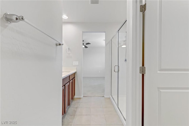 bathroom with ceiling fan, an enclosed shower, vanity, and tile patterned flooring