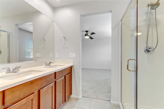 bathroom with ceiling fan, tile patterned flooring, a shower with door, and vanity