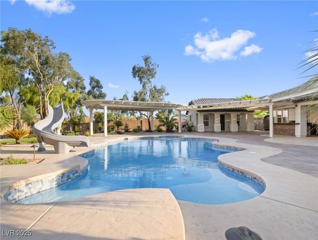 view of swimming pool with a water slide and a patio