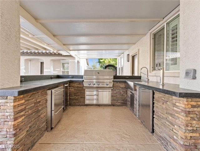 view of patio / terrace featuring grilling area, exterior kitchen, and sink