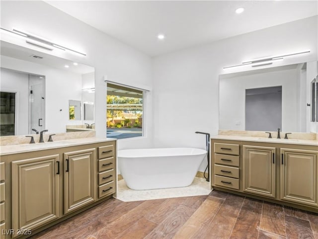 bathroom featuring vanity and independent shower and bath