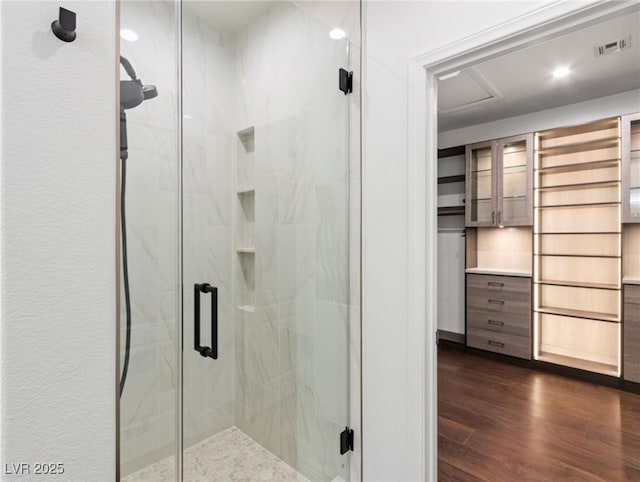 bathroom featuring wood-type flooring and walk in shower