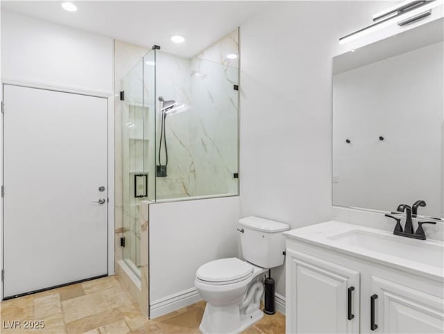 bathroom featuring vanity, toilet, and walk in shower