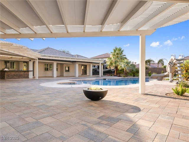 view of swimming pool with a pergola, a patio area, and a water slide