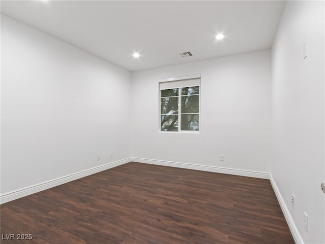 unfurnished room with dark hardwood / wood-style floors