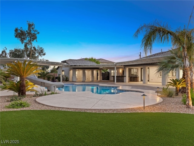 view of swimming pool featuring a patio area and a yard