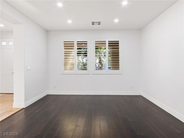 spare room with dark hardwood / wood-style flooring