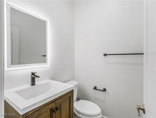 bathroom featuring toilet and vanity