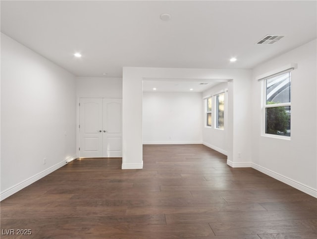 basement with dark hardwood / wood-style flooring