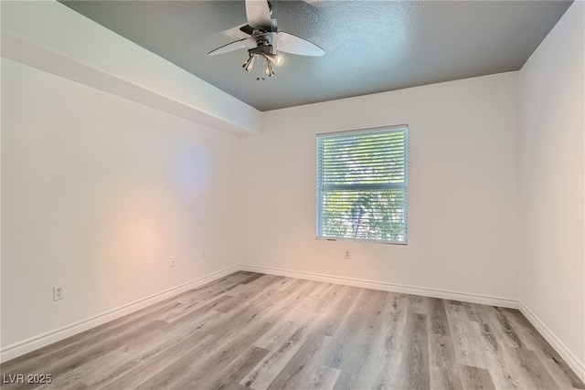 spare room with light hardwood / wood-style floors, a textured ceiling, and ceiling fan