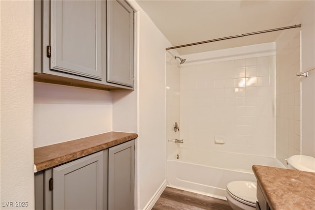 full bathroom with toilet, vanity, bathtub / shower combination, and hardwood / wood-style floors