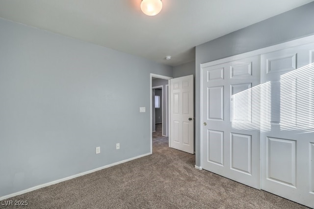 unfurnished bedroom with a closet and carpet