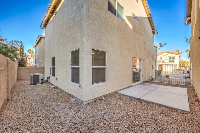 rear view of property with a patio area and cooling unit