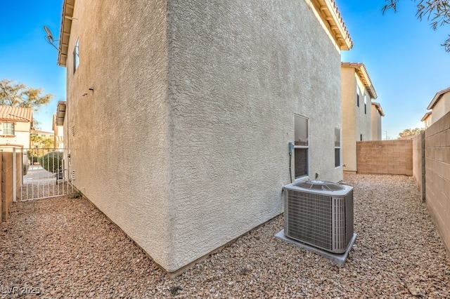 view of side of property featuring central air condition unit