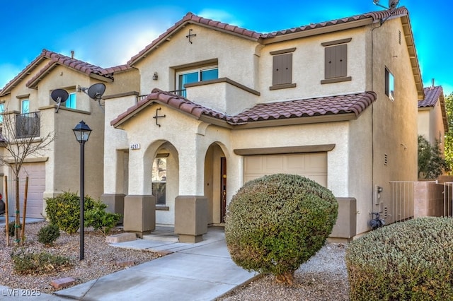 mediterranean / spanish-style home with a garage