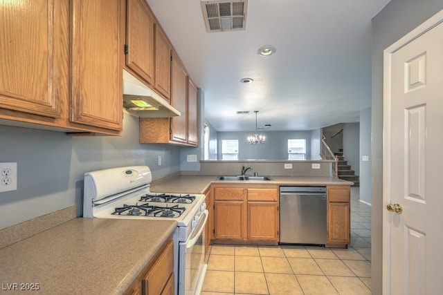 kitchen with dishwasher, gas range gas stove, sink, hanging light fixtures, and light tile patterned floors