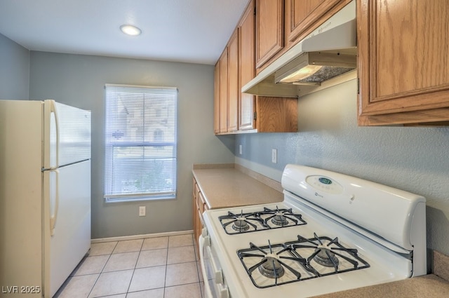 kitchen with light tile patterned floors and white appliances