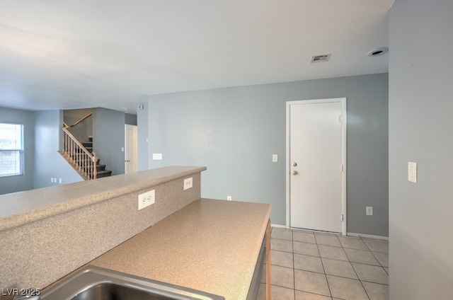 kitchen featuring sink and light tile patterned floors