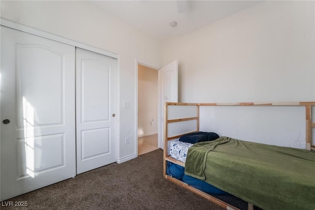 bedroom with a closet and dark carpet