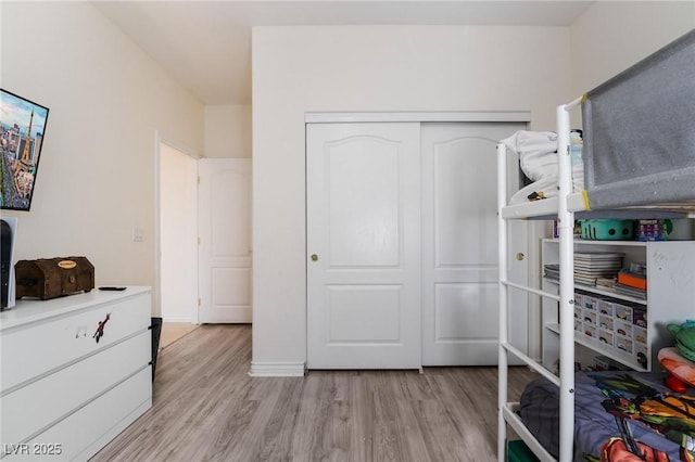 bedroom featuring a closet and light hardwood / wood-style flooring