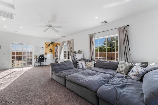 carpeted living room featuring ceiling fan