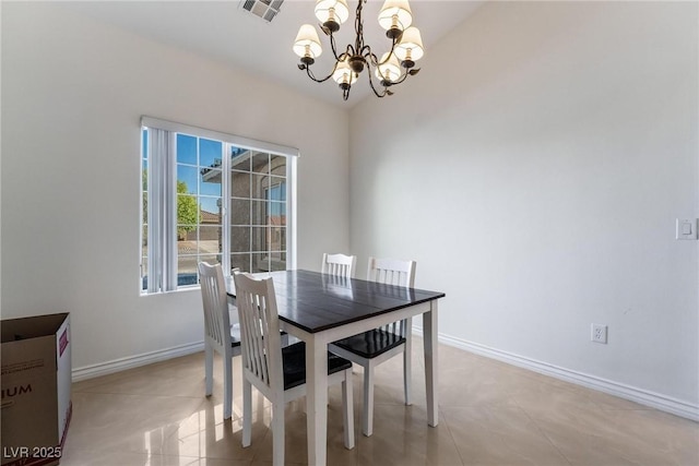 dining space featuring light tile patterned floors and an inviting chandelier