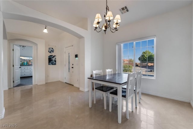 dining area featuring a notable chandelier