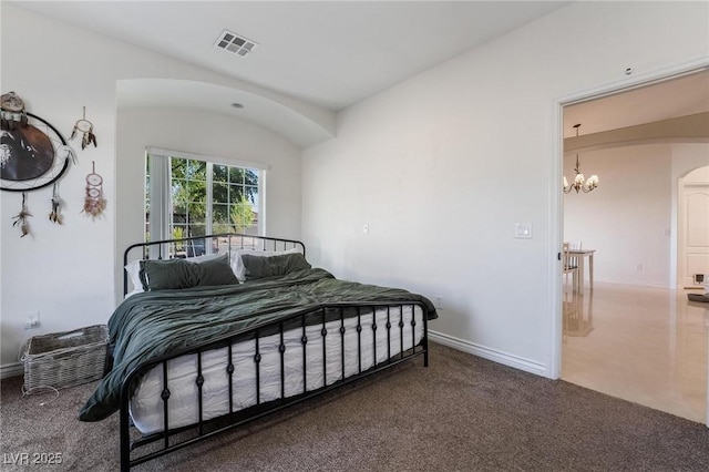 bedroom with carpet flooring and a chandelier