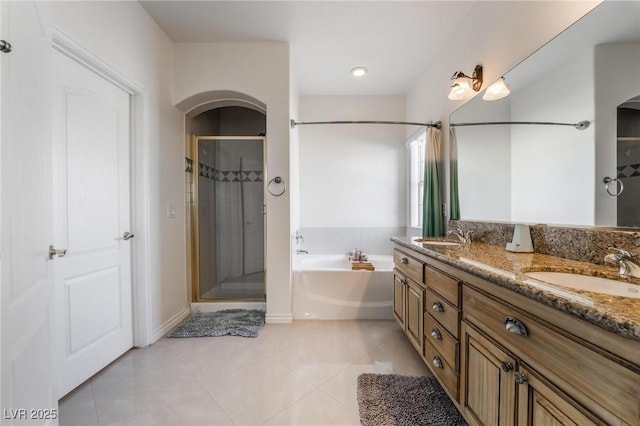 bathroom featuring plus walk in shower, tile patterned floors, and vanity