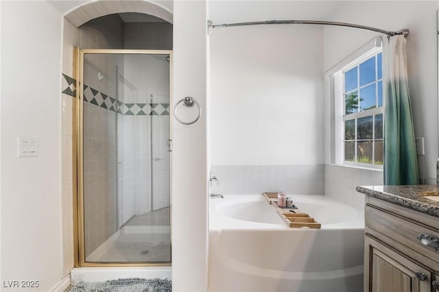 bathroom featuring vanity and shower with separate bathtub